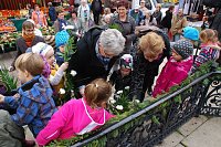 Bild: Blumen f&uuml;r das Geburtstagskind. Sp&auml;ter wurde der zur Vase umfunktionierte Eimer auf die Stufe vor das Denkmal gestellt.