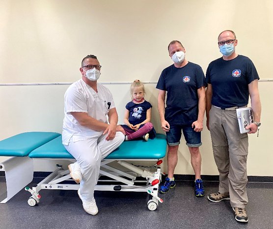 Bevor es ins k&uuml;hle Nass mit den Kindern geht, gibt es einiges zu beachten. J&ouml;rg und Frank Siegert von der Wasserwacht zeigen gemeinsam mit Oberarzt Sebastian Massel worauf es ankommt. V.L.: Sebastian Massel mit Tochter Vida, J&ouml;rg und Frank Siegert. (Foto: Helios Klinik )