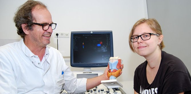 Chefarzt Dr. Kothe erkl&auml;rt Linda die Schilddr&uuml;se an einem Modell. (Foto: Gabriele Lakomy)